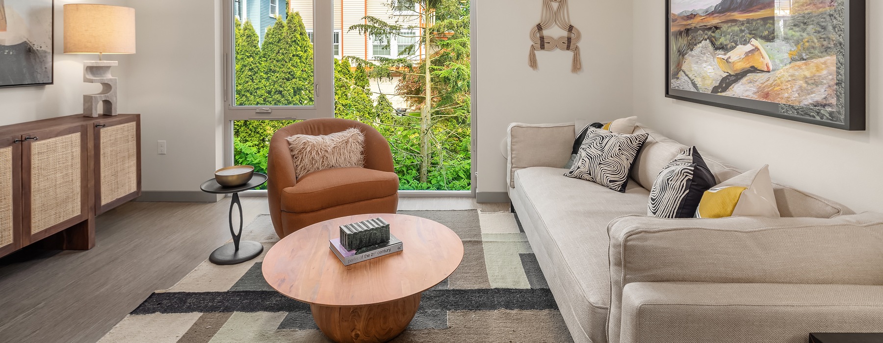 Living room with gray couch and large window